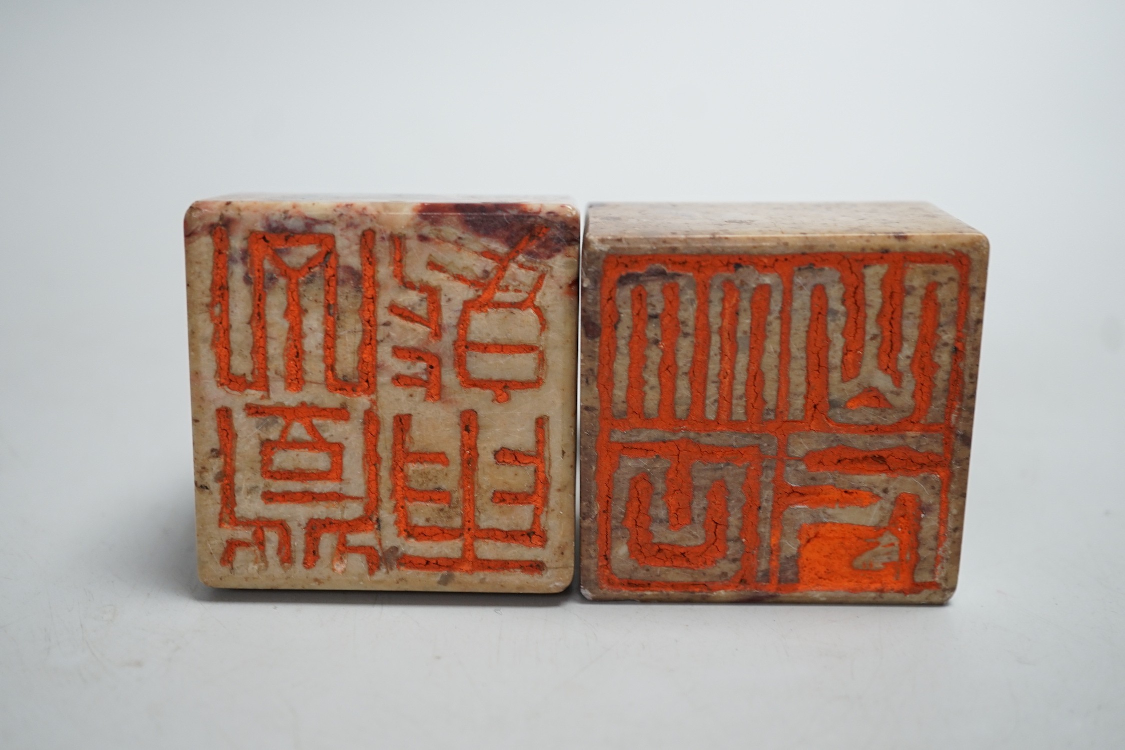 A pair of Chinese carved soapstone chop seals decorated as seated toads, 6cm